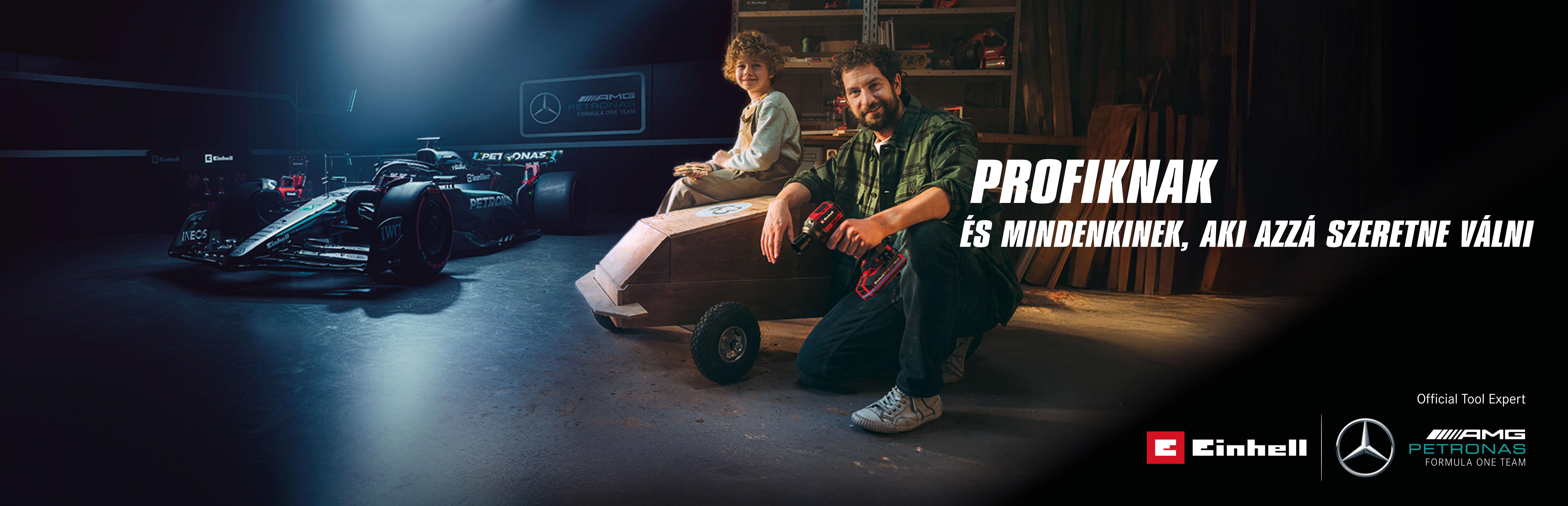 Egy apa és gyermeke egy műhelyben egy házilag készített szappantartó autóval. A háttérben egy Mercedes-AMG PETRONAS Forma–1-es autó és Einhell szerszámok. Jobbra a szöveg olvasható: „A profiknak és azoknak, akik azzá akarnak válni.”