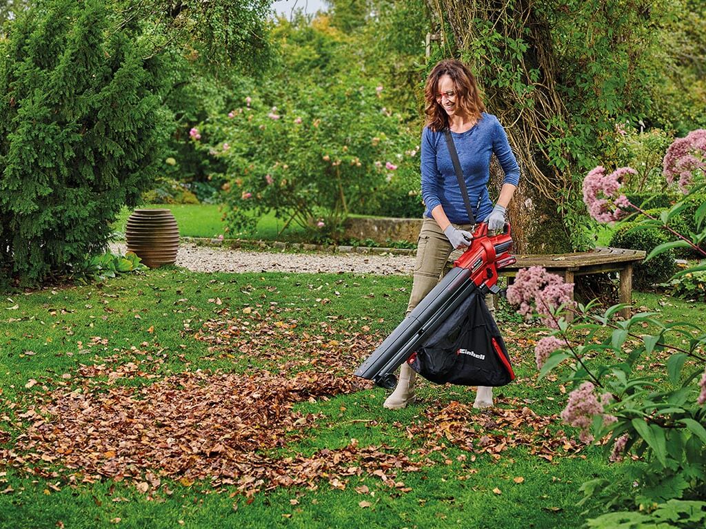 A woman using the leaf vacuum 