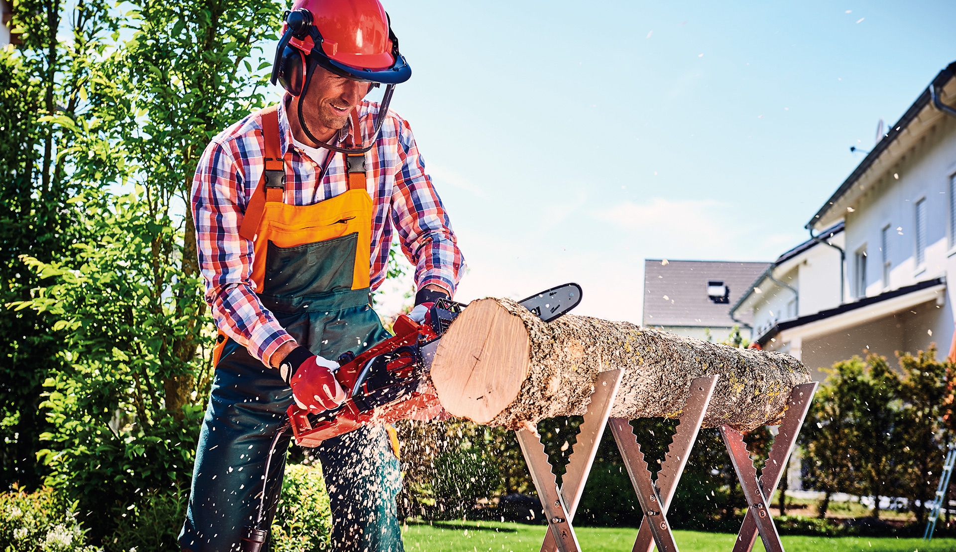 A man cuts a trunk with a chainsaw