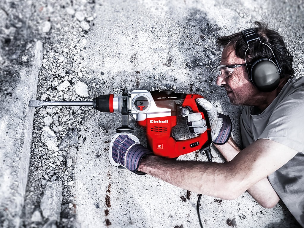 A man drills pieces from a stone