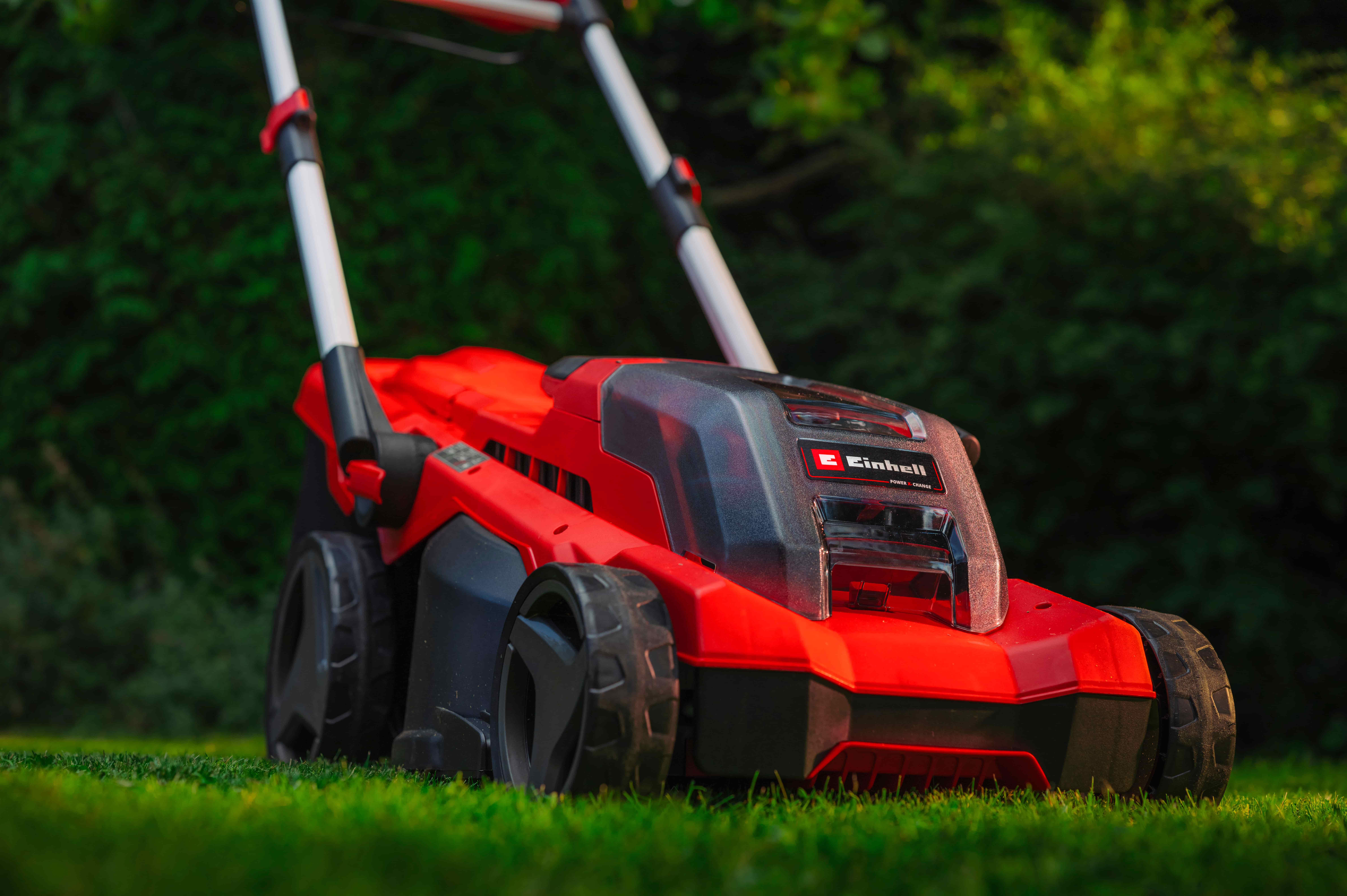 Einhell cordless lawn mower mowing the lawn in the garden.
