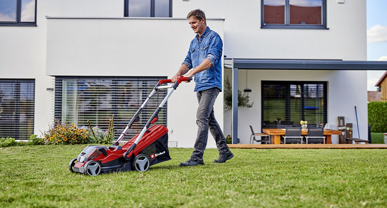 A man mowing the lawn with the Einhell lawn mower