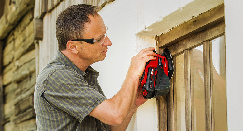 man using cordless multi-sander