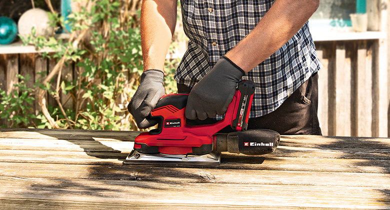 man using grinder for sanding wood