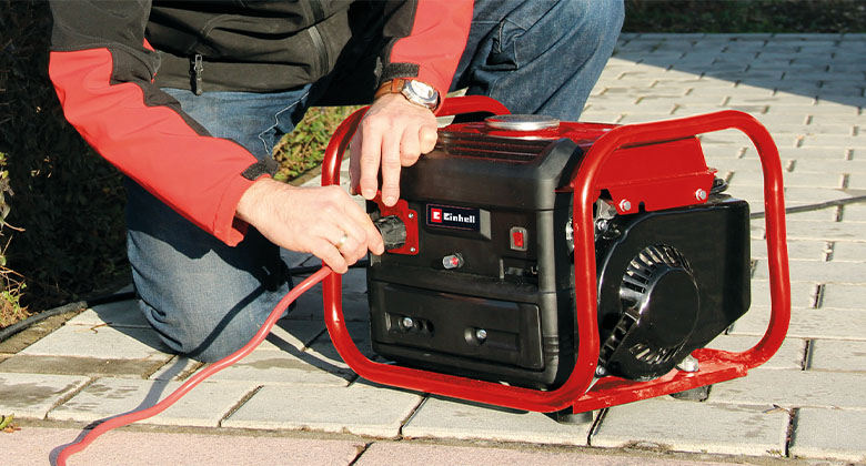 man connecting cable on power generator